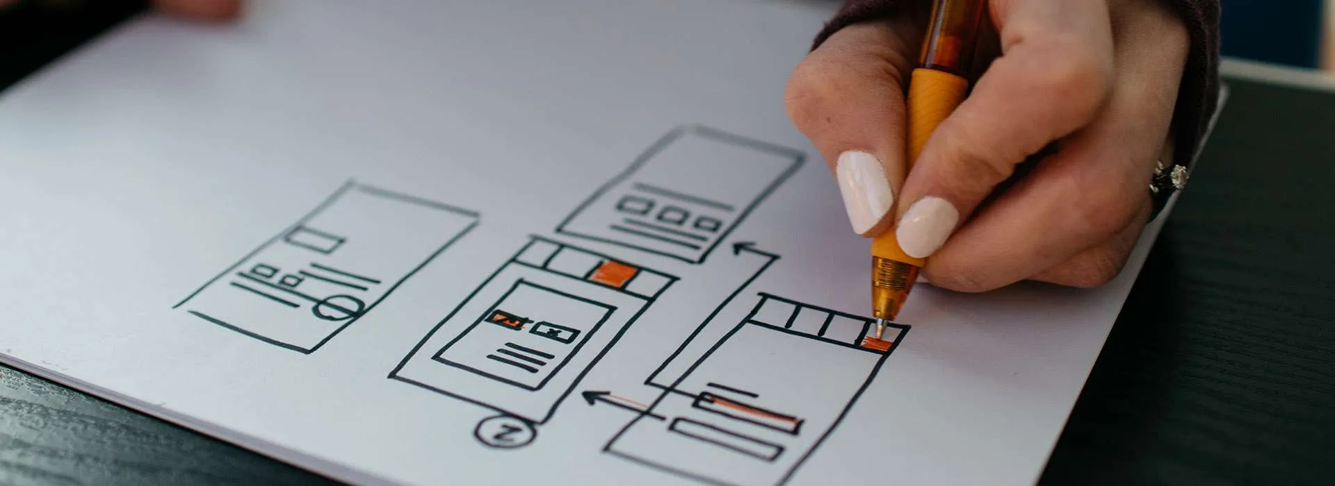 person sketching a wireframe