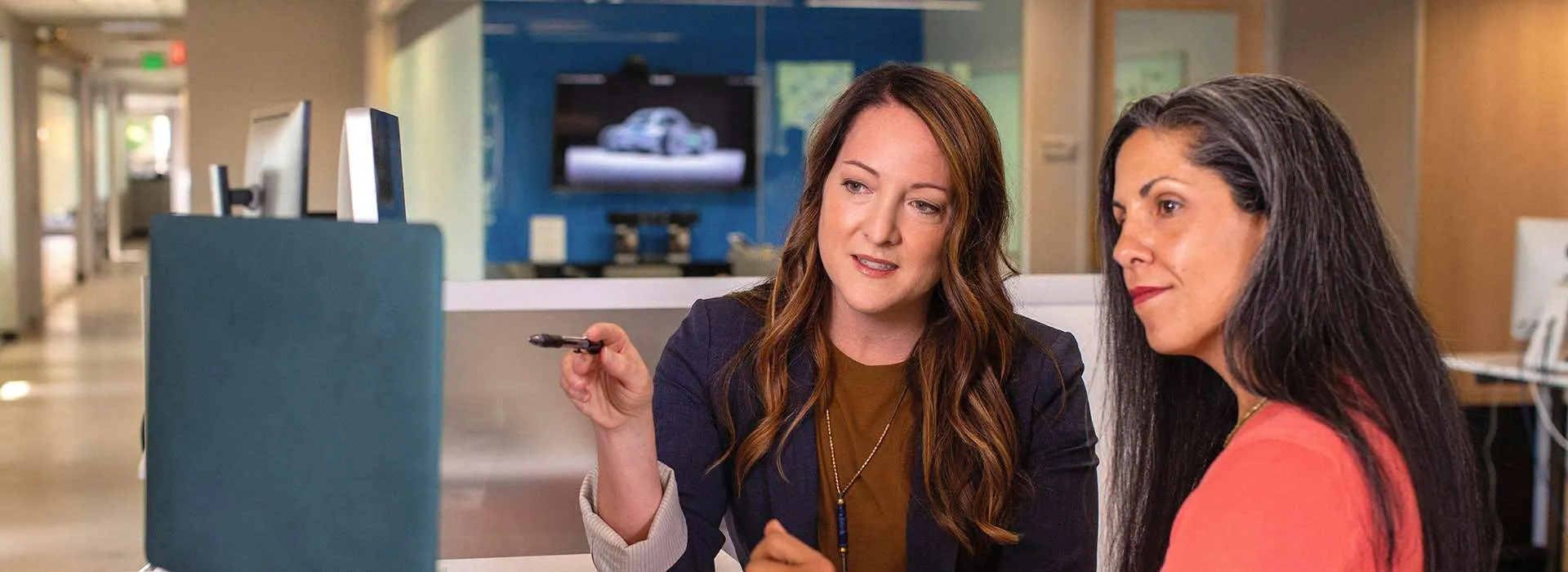 Two women looking at a laptop screen