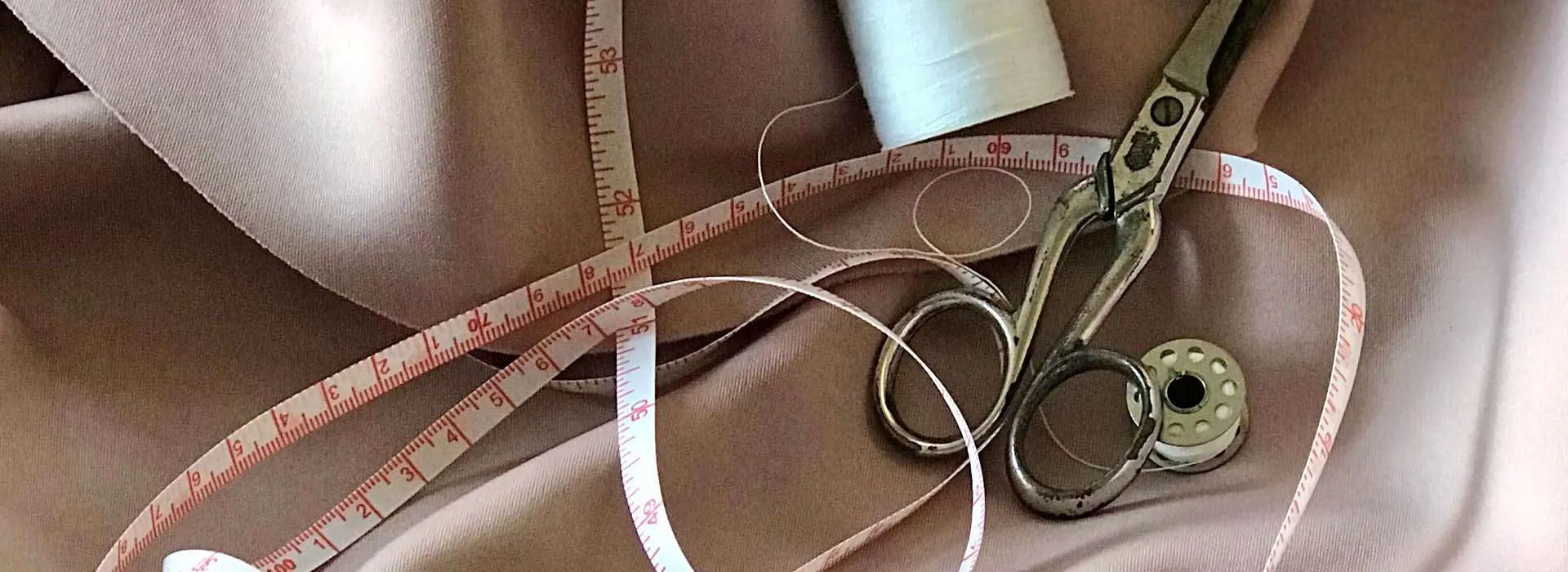 material, measuring tape, scissors and thread