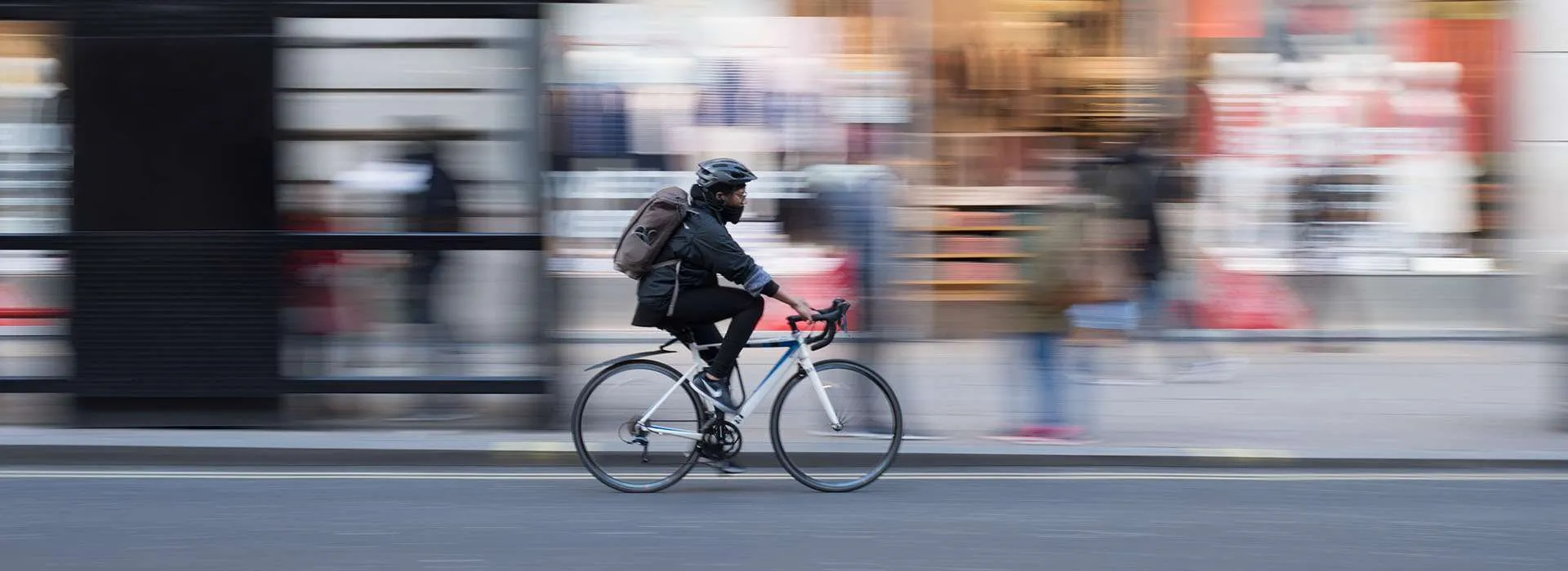 cyclist travelling down a busy street