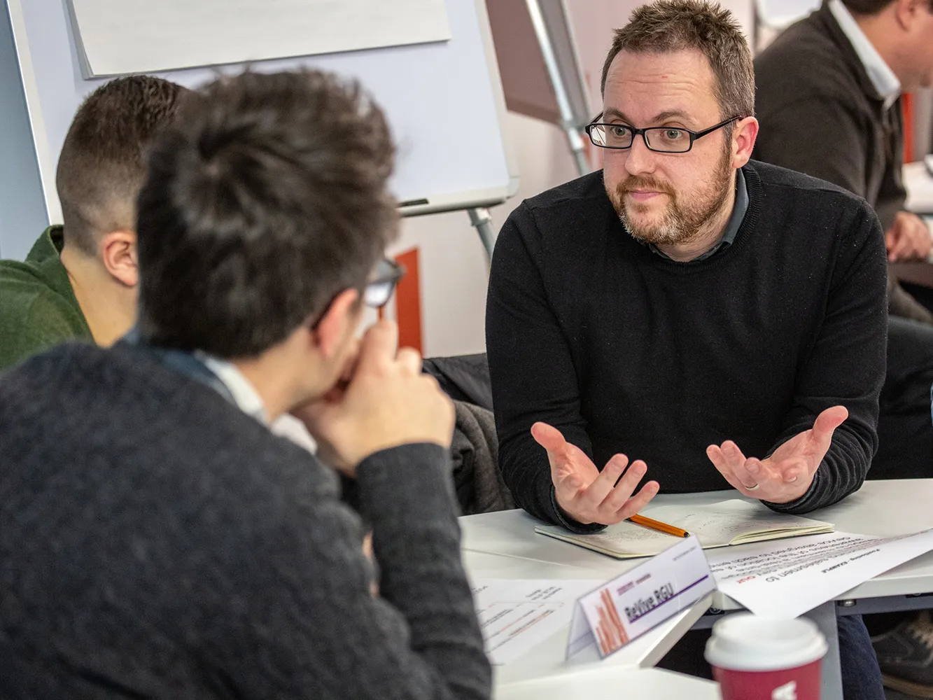 three people having a business chat