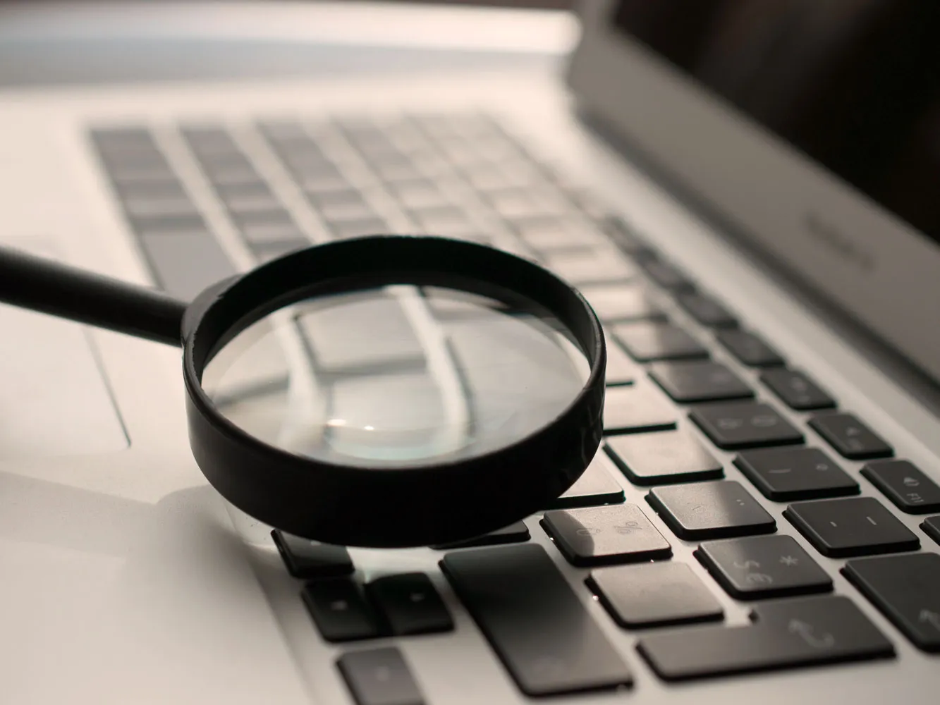 magnifying glass on laptop keyboard