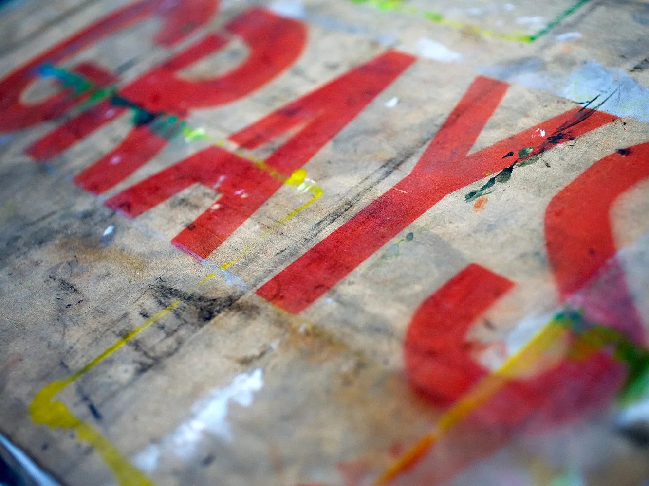 red print on wood of the word