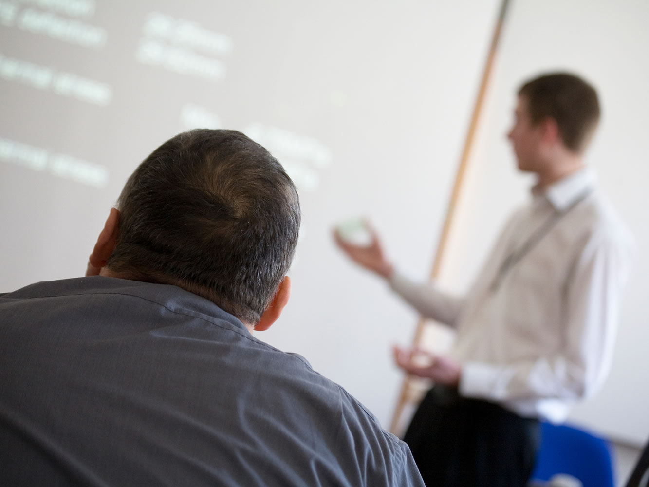 person listening to someone else's presentation
