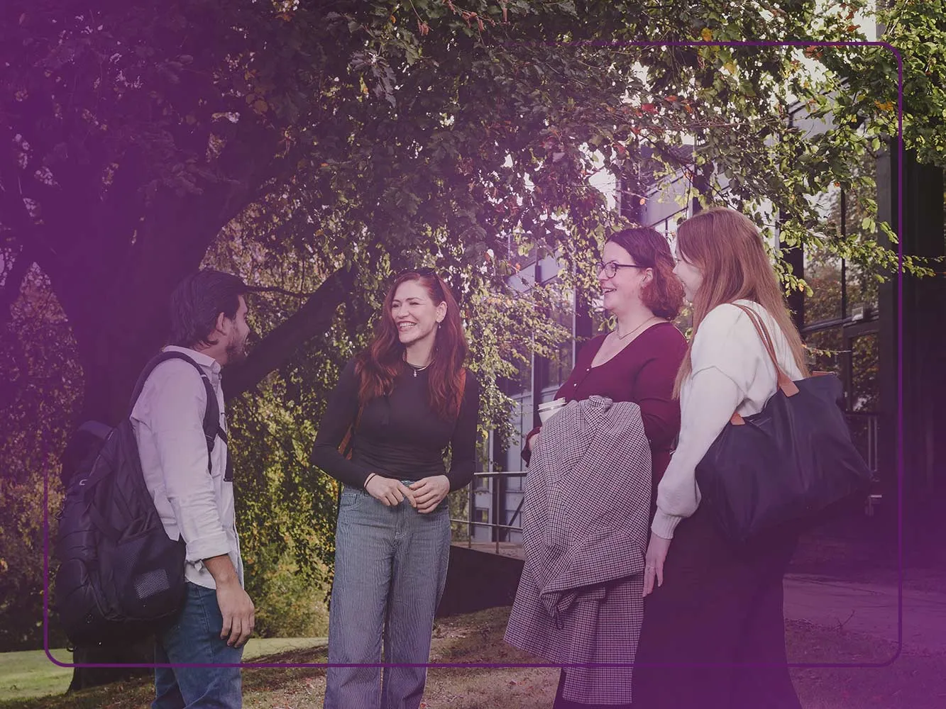 Four students talking outside of Gray's School of Art on the RGU campus