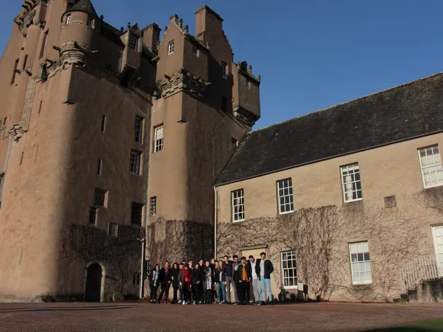 a group of students outside of crathes castle