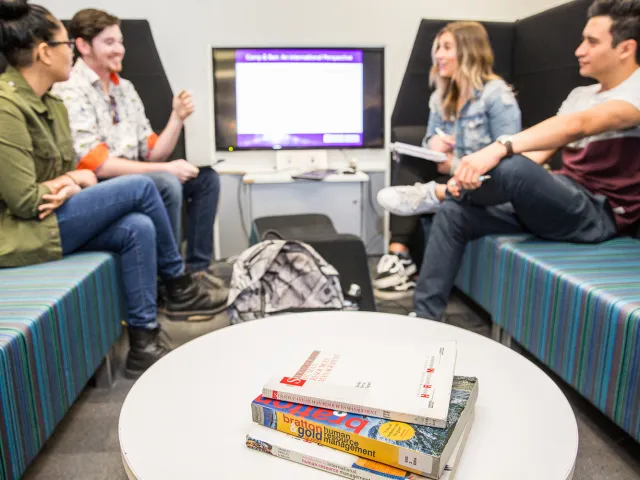 students chatting in a study pod