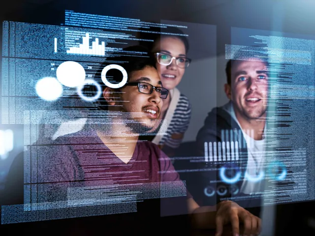 three people looking at a transparent futuristic display