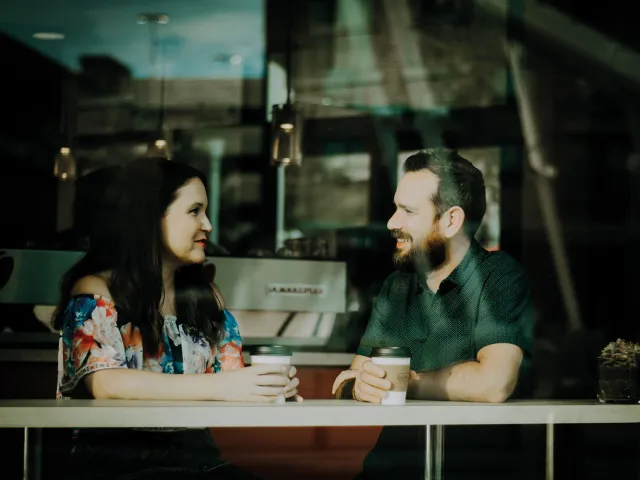 two people having a conversation at a cafe