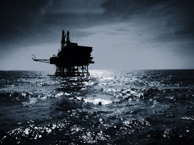 dramatic photo of an oil rig at sea