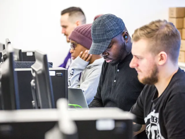 students looking at computers in lab