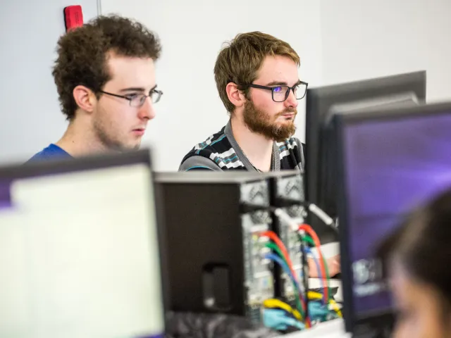 students looking at computers in lab