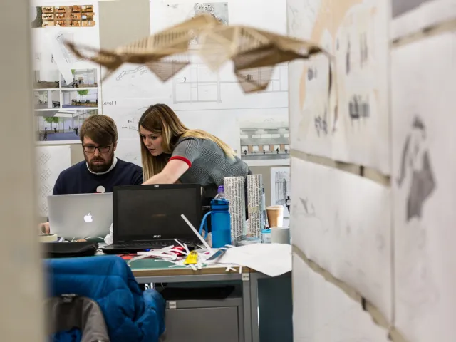 people chatting in architectural workshop