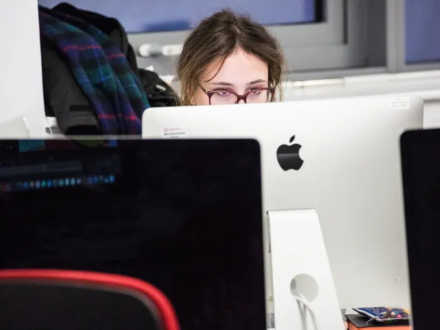 student working on mac in digital suite