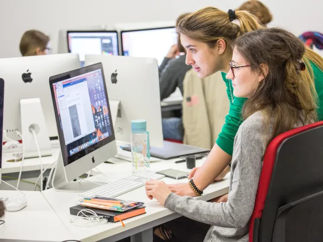 students looking at computer in lab