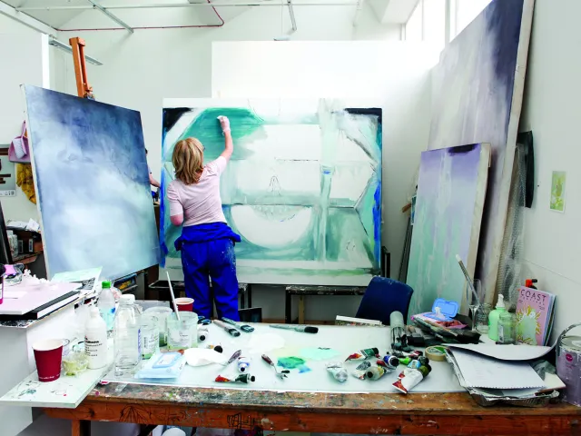 woman painting on a large canvas