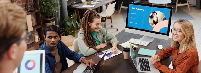 people at a computer having a meeting