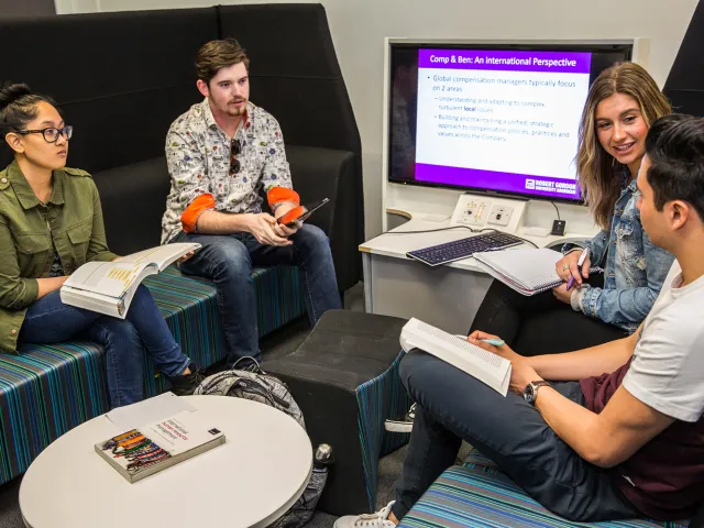 students chatting in a study pod