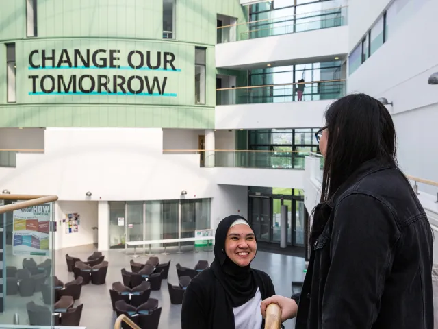 students wearing headscarves in the back atrium of sir ian wood building