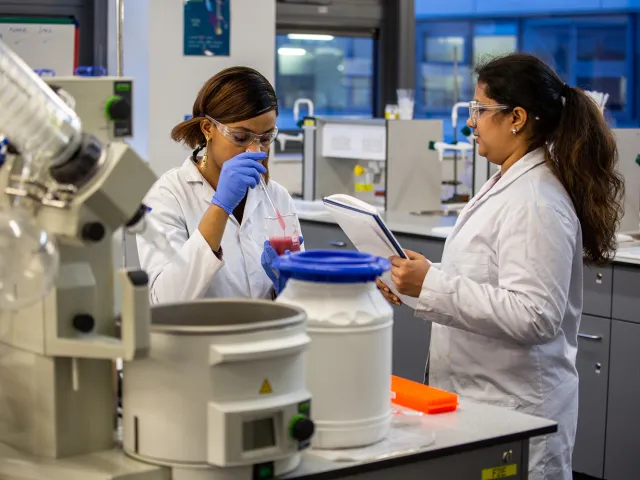 people looking at scientific equipment