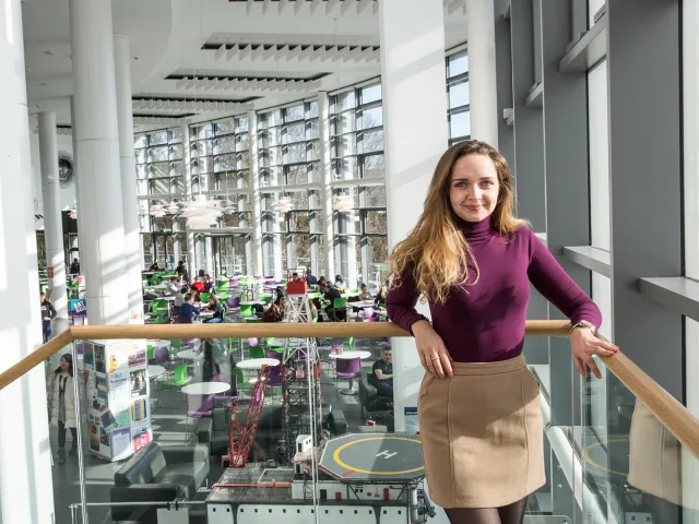 student standing on stairs in sir ian wood building