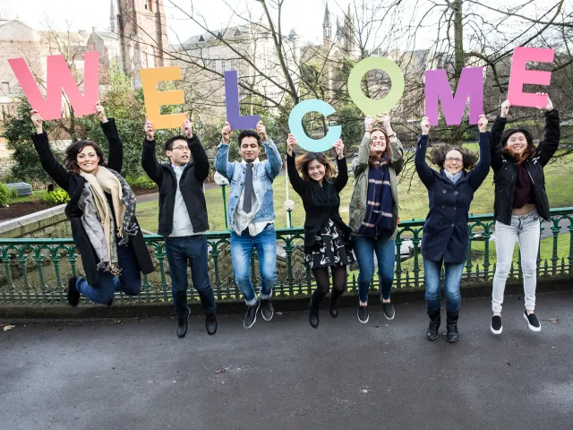 students holding up letters that spell