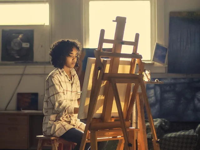 Person painting at an easel