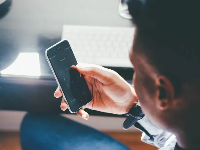 man looking at his mobile phone