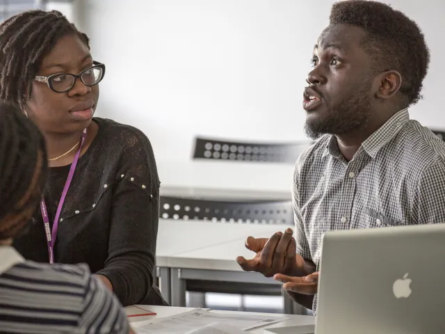 two people speaking in a classroom