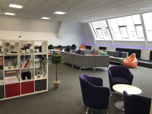 modern room with comfortable seating and bookshelves