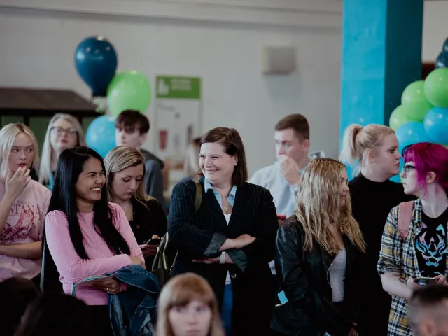 students and staff chatting together