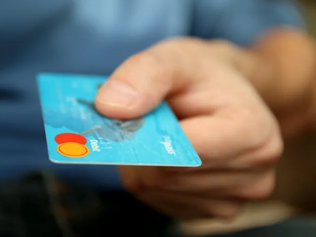 hand holding a debit card