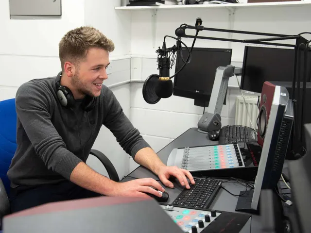 student talking into mic in Radio Studio