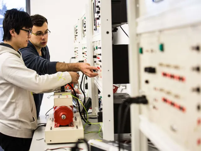 students using an electrical control panel