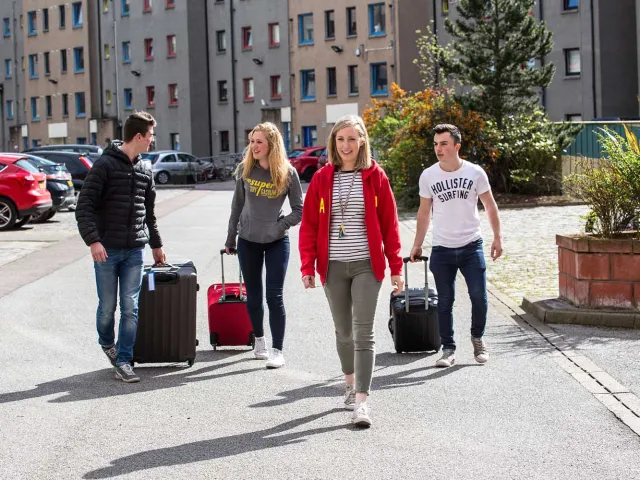 ResLife staff smiling outside accomodation