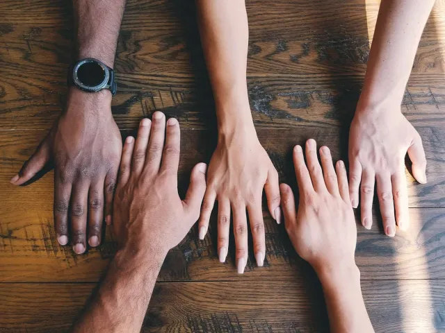 diverse collection of hands on a table