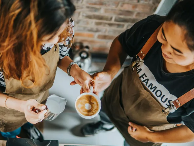 two people making a coffee