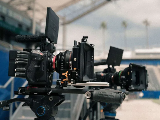 two professional camera rigs set up on tripods