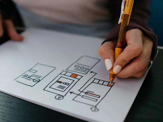 person sketching a wireframe