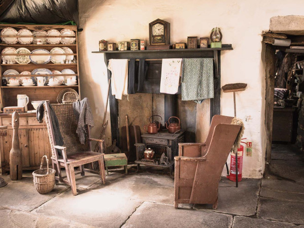 Old fashioned chairs sat around a fireplace