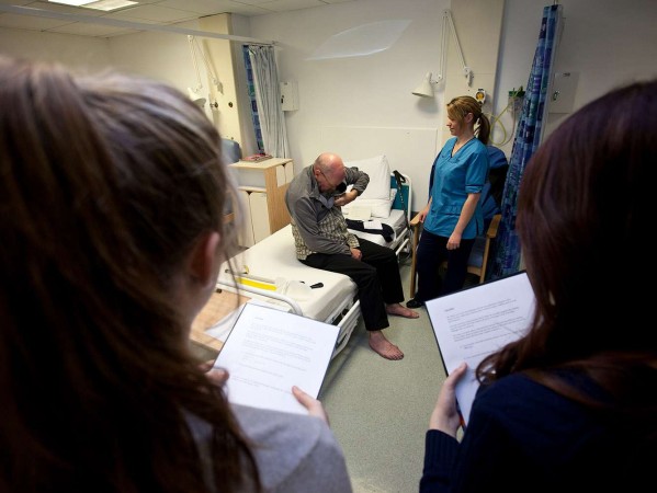 students taking notes as patient explains his symptoms