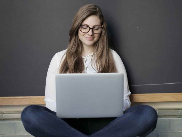 woman sitting cross legged with her laptop